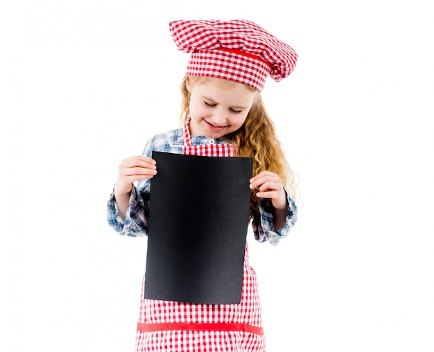 Little chef girl holding piece of paper with free space, isolated