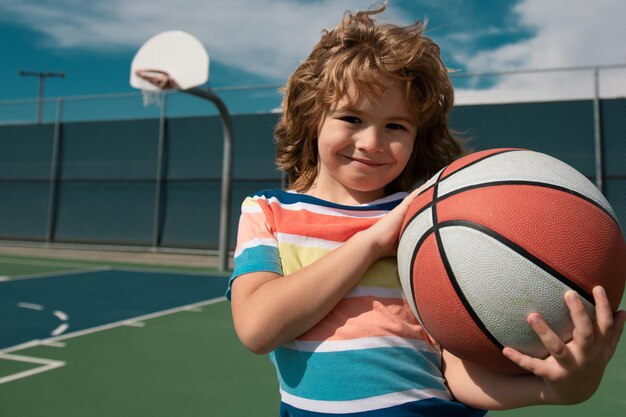 Photo little child boy playing basketball with basket ball active kids lifestyle basketball school