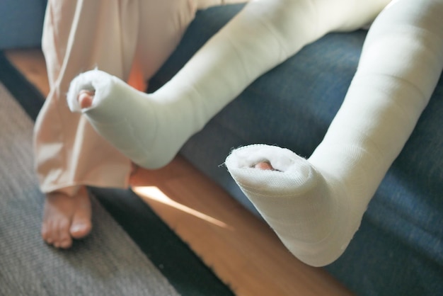 Little child boy with plaster bandage on leg