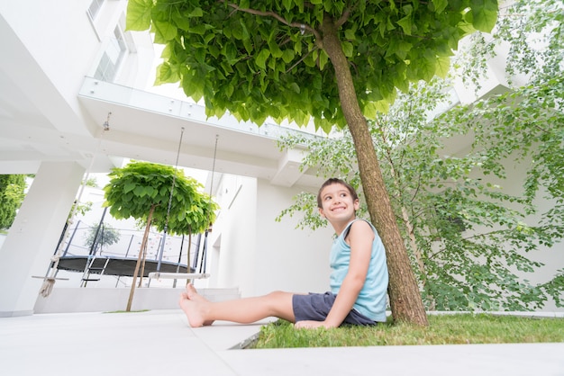 Little child in front of modern house