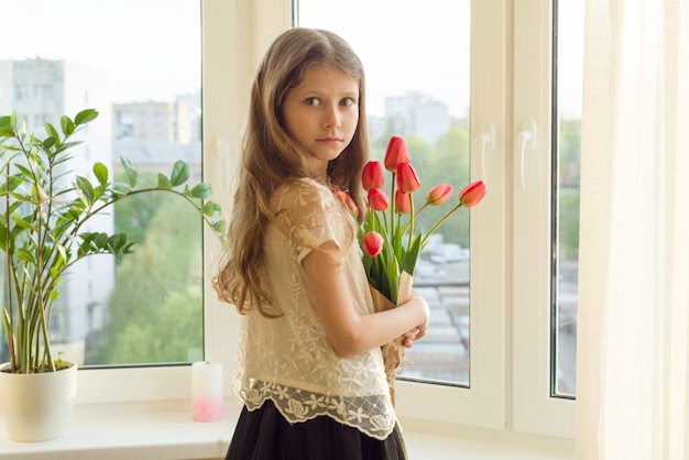 Little child girl holding bouquet