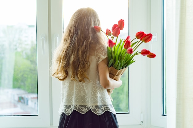 Little child girl holding bouquet