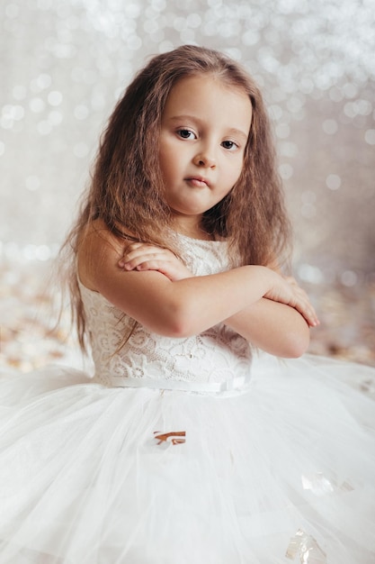 Little child girl in princess dress on confetti background