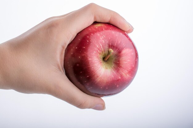 Little child hand holding an apple