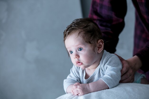 Little child lying down in fitball during morning work-out