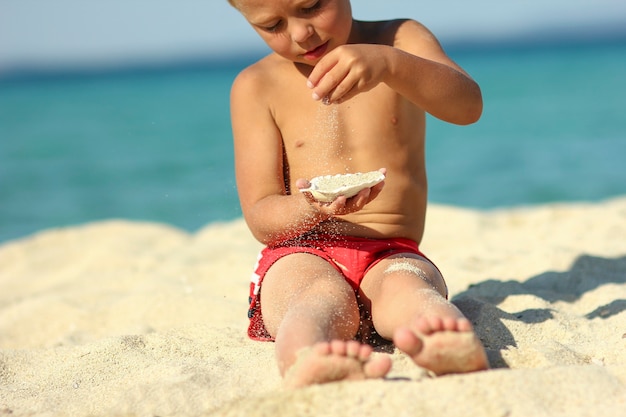 Little child play on the beach seashore