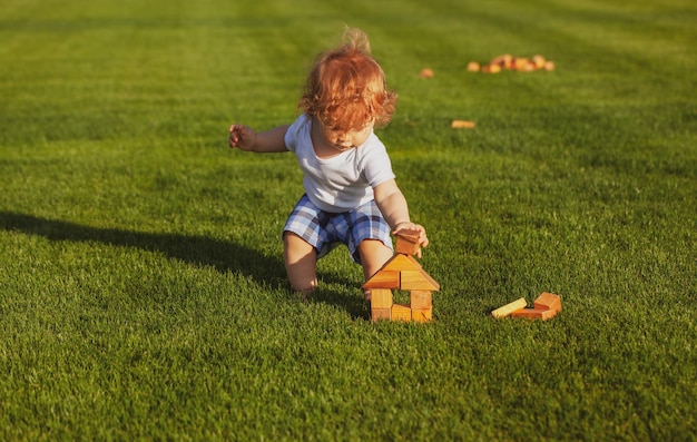 Little child play in park Portrait of a happy baby in grass field