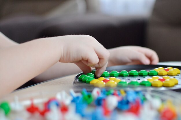 Little child playing with mosaic