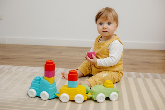 Little child playing with toy train