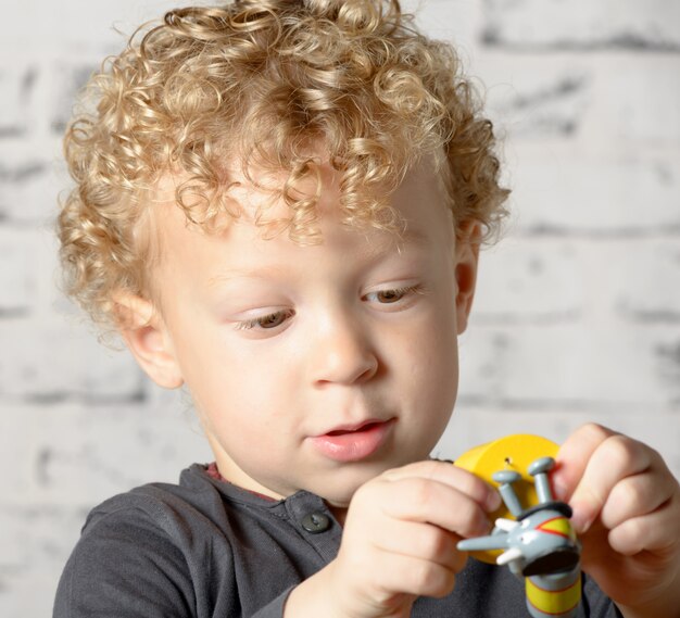 A little child plays with toys animals