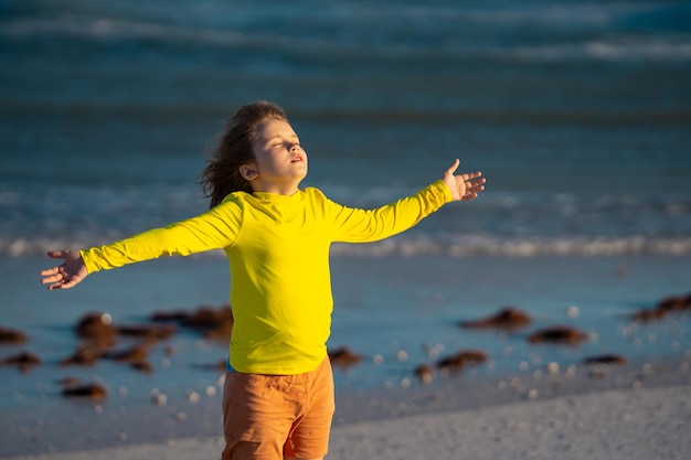 Little child running on the beach on sunrise happy amazed kid running on sea beach cute child runnin