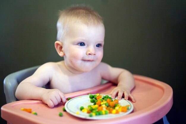 Little child sitting on a high chair