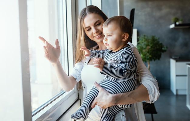 Little child smiling and happy with mom on the sofa