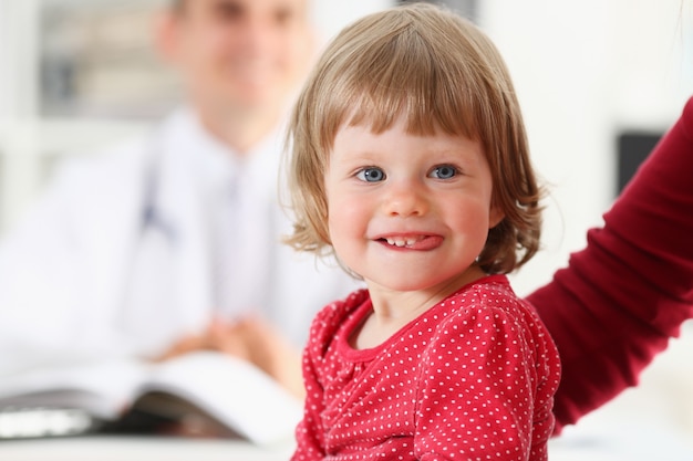 Little child with mother at pediatrician reception. 