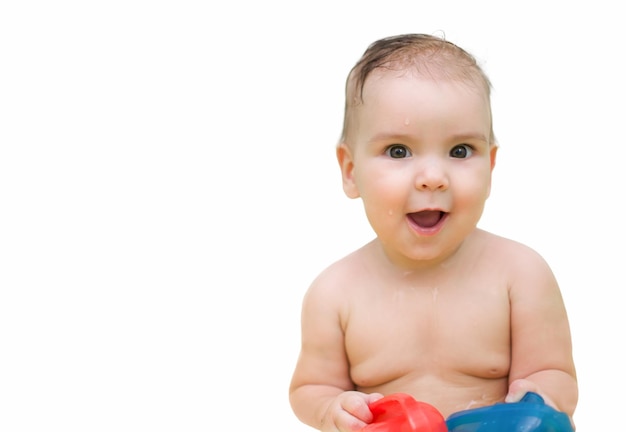 Little child without clothes with toy boats on an isolated white background Baby shower concept