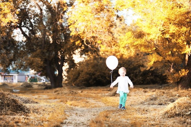 Little children are walking in autumn park