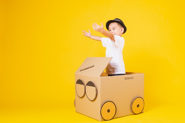 Little children boy driving carton car