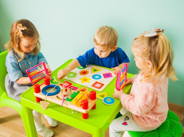 Little children learn geometric shapes at home Early development concept