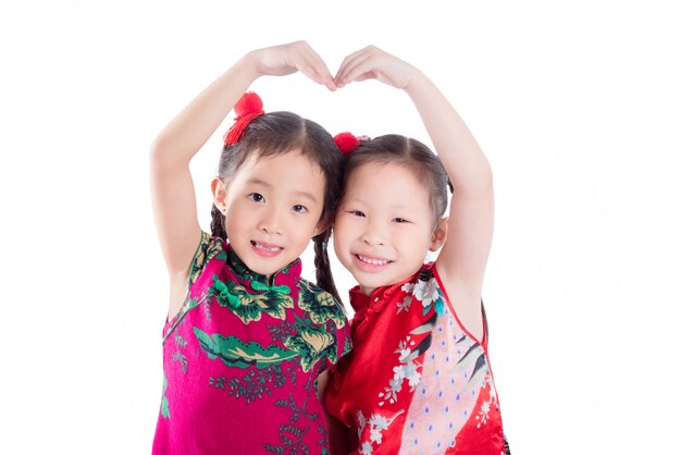 Little chinese girls doing heart shape