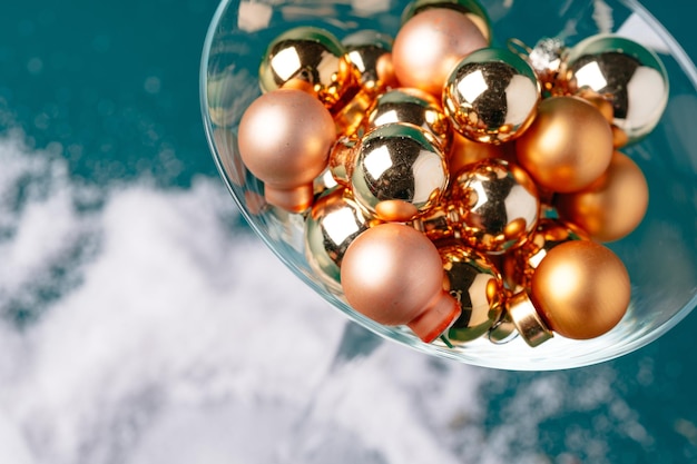 Little christmas baubles in wineglasses on a dark background