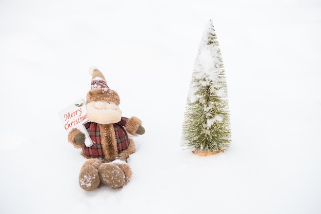 Little Christmas tree and santa claus in snow outdoor. Merry christmas. happy new year. High quality photo