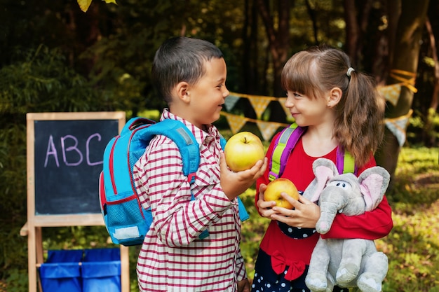 Little classmates with backpacks. Back to school. The concept of education, school