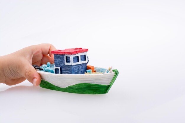 Little colorful model boat in hand