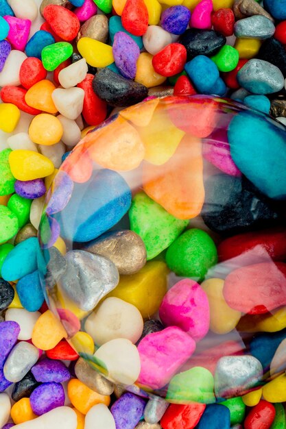 Little colorful stones as a background under a lens