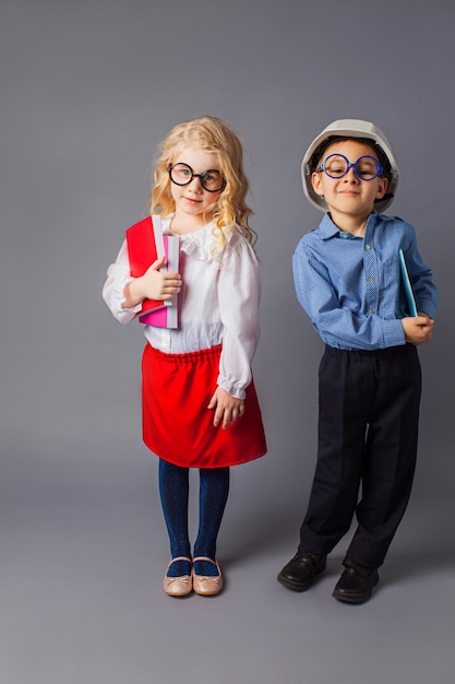 The little couple in costumes of teacher and engineer