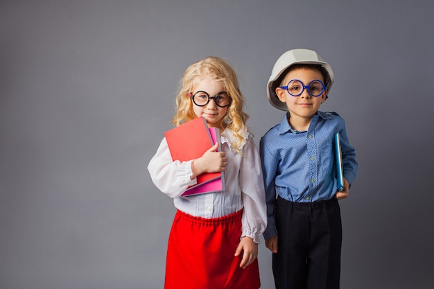 The little couple in costumes of teacher and engineer