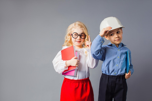 The little couple in costumes of teacher and engineer