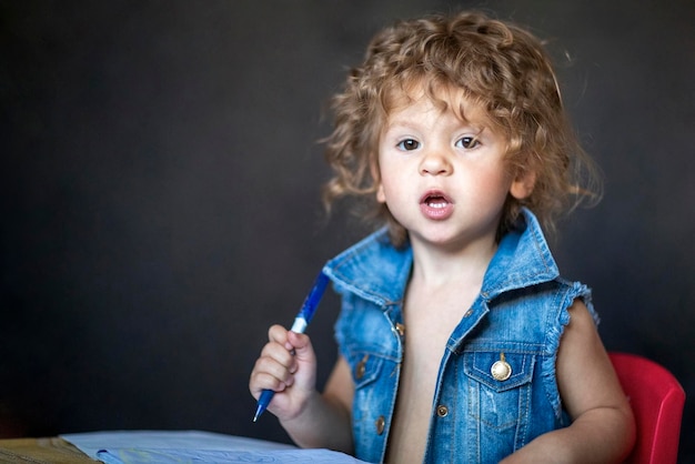 Little curly little curly girl is surprised shows emotion is\
surprised shows emotion high quality photo