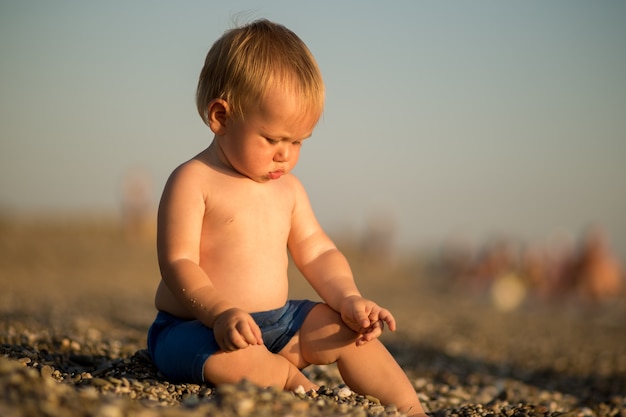 Little cute baby boy on the beach