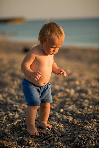 Little cute baby boy on the beach