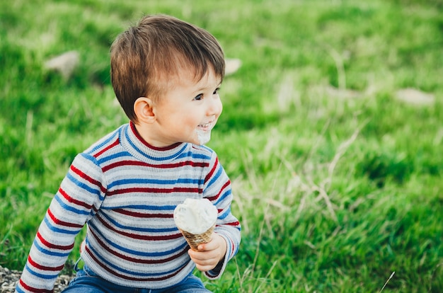 Little cute boy eating ice cream