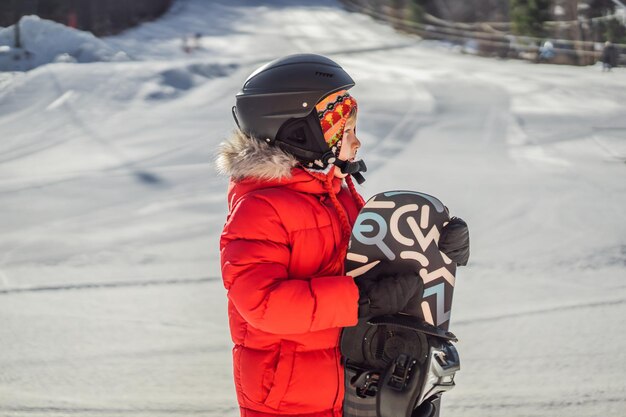 Little cute boy is ready for snowboarding Activities for children in winter Children's winter sport Lifestyle