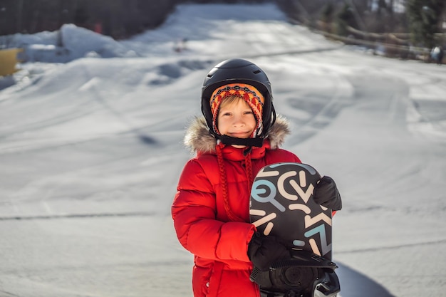 Little cute boy is ready for snowboarding Activities for children in winter Children's winter sport Lifestyle