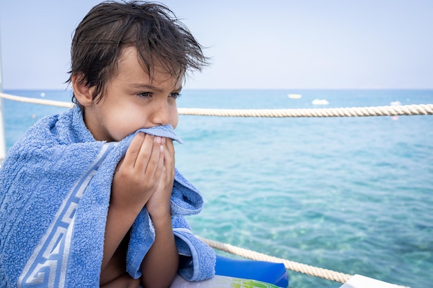 Little cute boy on sea pier enjoying vacation