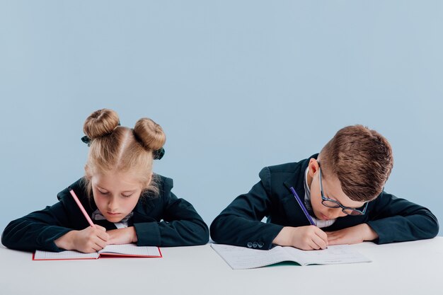 Little cute girl and boy wearing black suits with bows