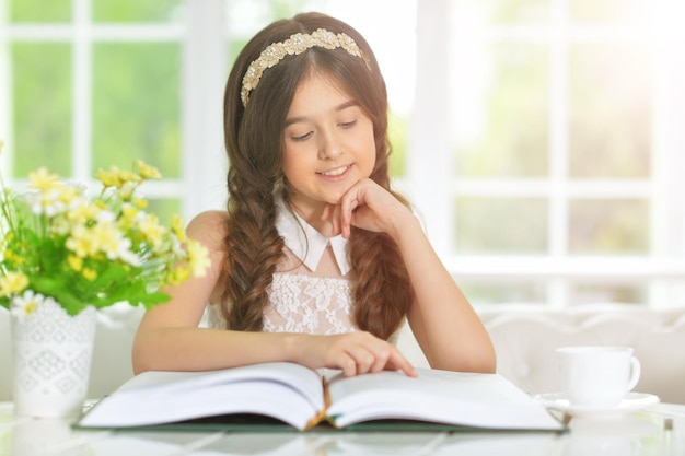 Little cute girl reading book