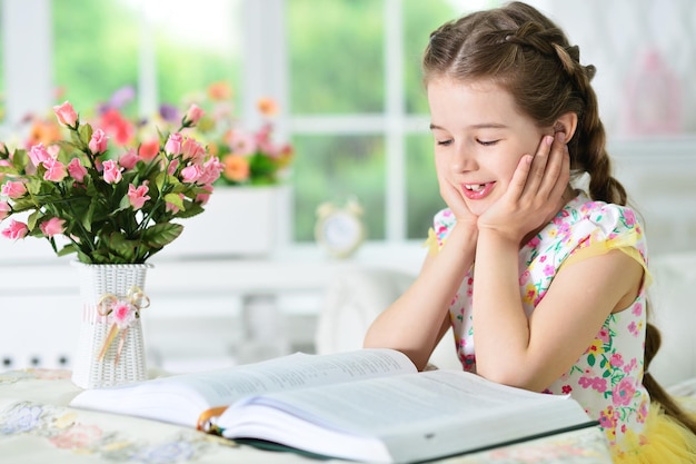 Little cute girl reading book