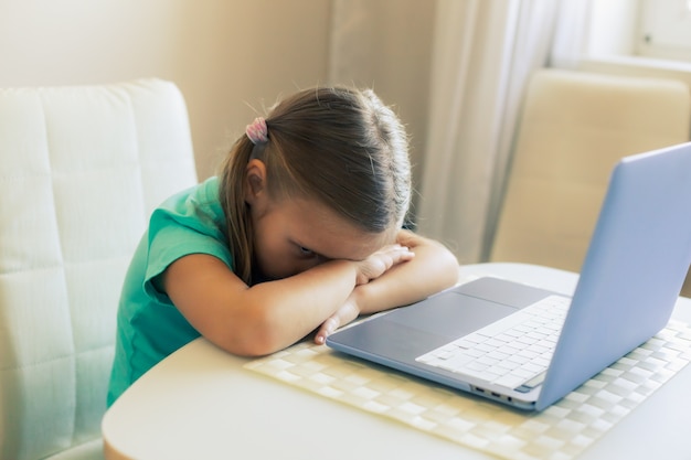 Little cute girl uses laptop to have video call