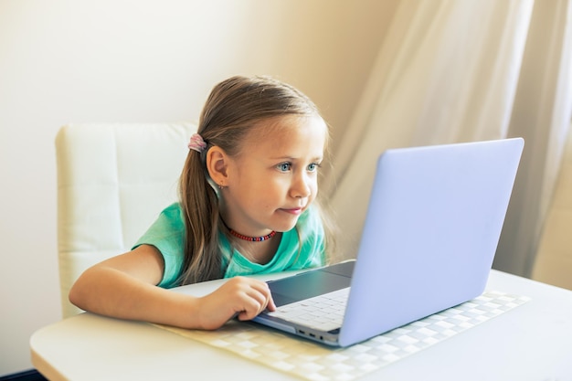 Little cute girl uses laptop to have video call