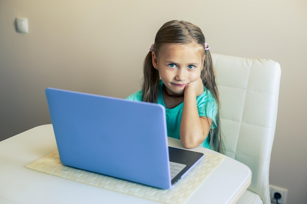 Little cute girl uses laptop to have video call