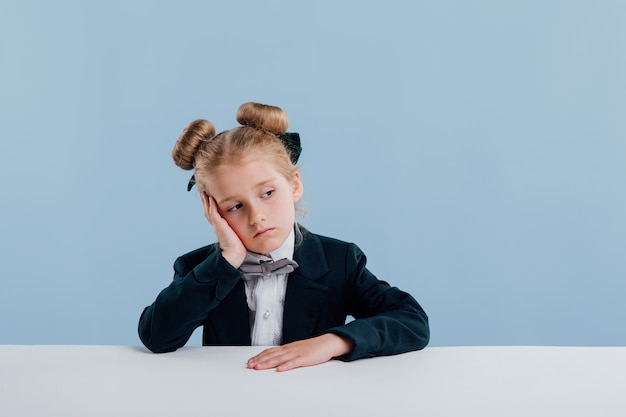 Little cute girl wearing a black suit and a bow