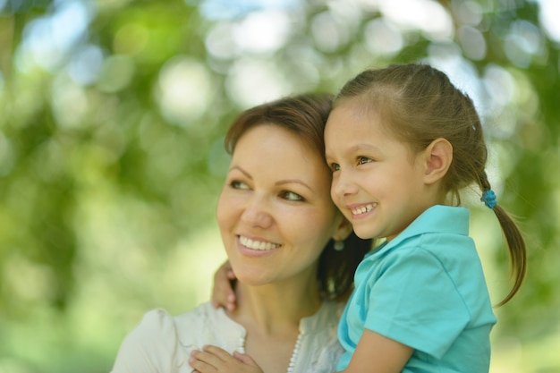 Little cute girl with mother in park