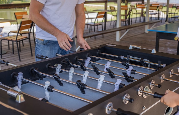 little cute kid boy having fun spend free leisure time enjoy playing table soccer or football game