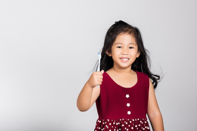 Little cute kid girl show brush teeth and smile