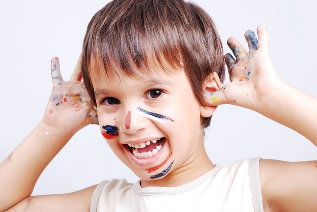 Little cute kid with colors on his face