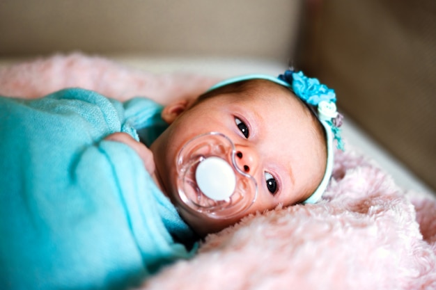 Little cute newborn baby girl in the bed